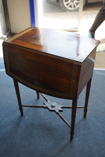 A Regency brass inlaid rosewood bowfront drop leaf work table, width 54cm, depth 36cm, height 70cm